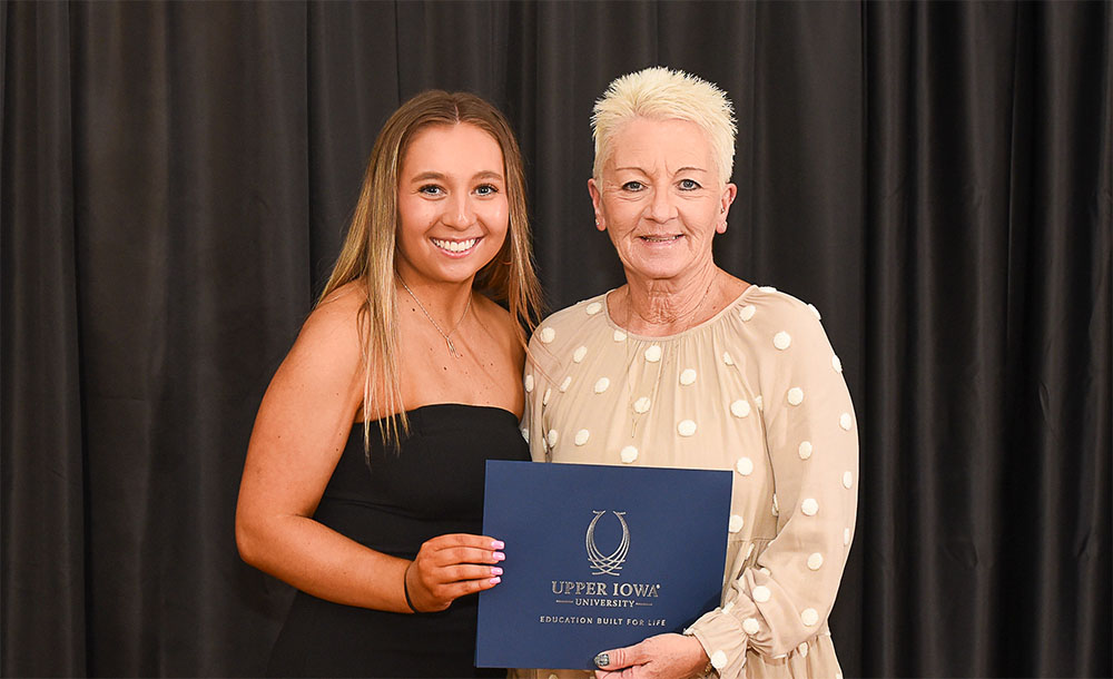 Julie Games of West Union, IA, presented the Martin & Julie Games Cheer & Dance Scholarship to 2025 recipient Madelyn Wolf of Atkins, IA