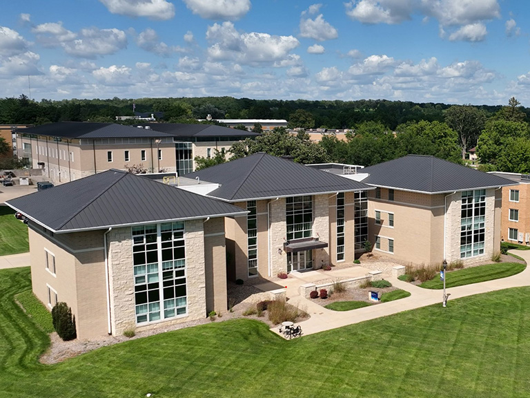 Drone view of a large sandstone colored buidling