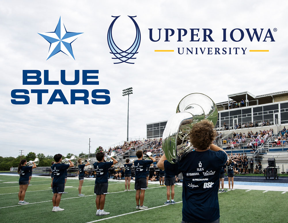 A low angle of a marching band in formation with a few up to a crowd of spectators. The Blue Stars and Upper Iowa University logos are present