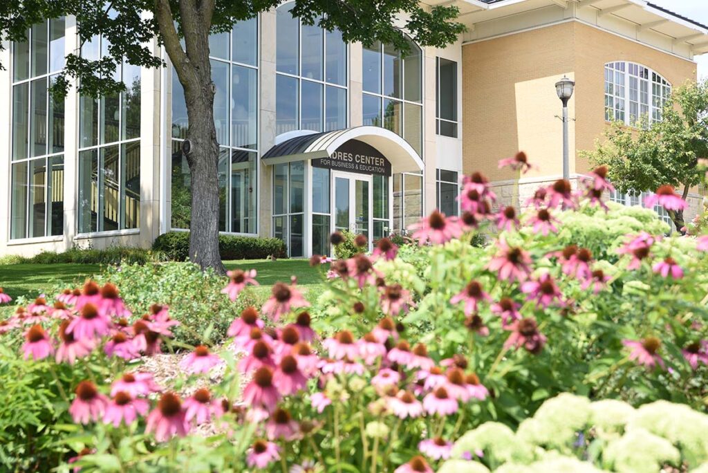 A building with glassy exterior with purple coneflowers in the foreground