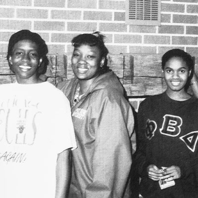 A black and white photo of students posing, some with greek life shirts