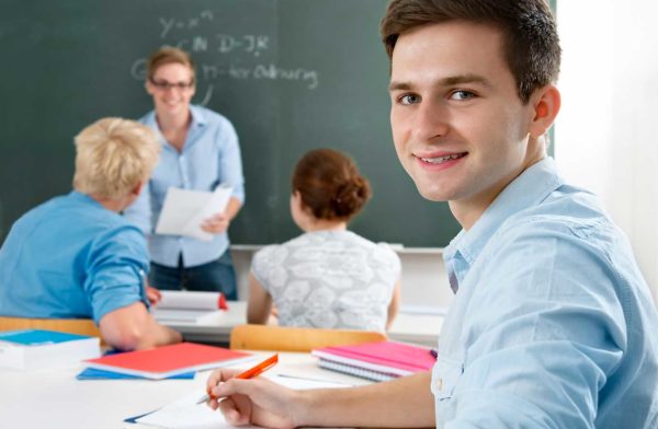 student in class looking at camera (stock)