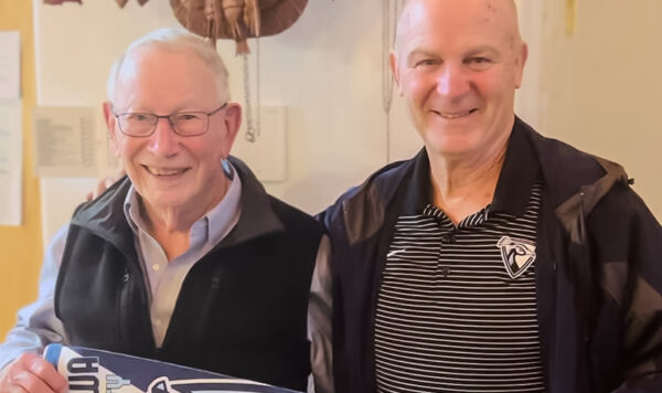 Jim Odle and Dr. Duffy hold a UIU Alumni pennant.