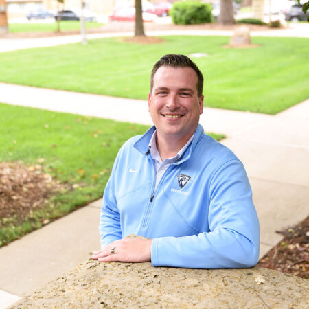 Photo of Josh Gredys on a sunny day with a green lawn in the background