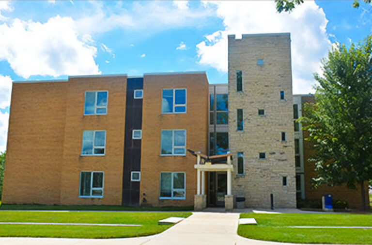 A large building with orange and sand colored bricks, with a large central