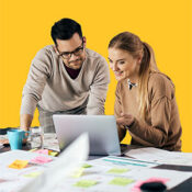 Marketing professionals reviewing work on a laptop