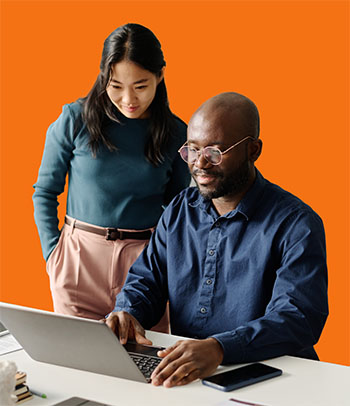 Two adults collaborate around a laptop