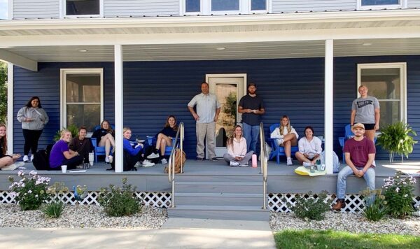 UIU's Student Philanthropy Council and UIU Staff gather on the newly rennovated Alumni House Porch