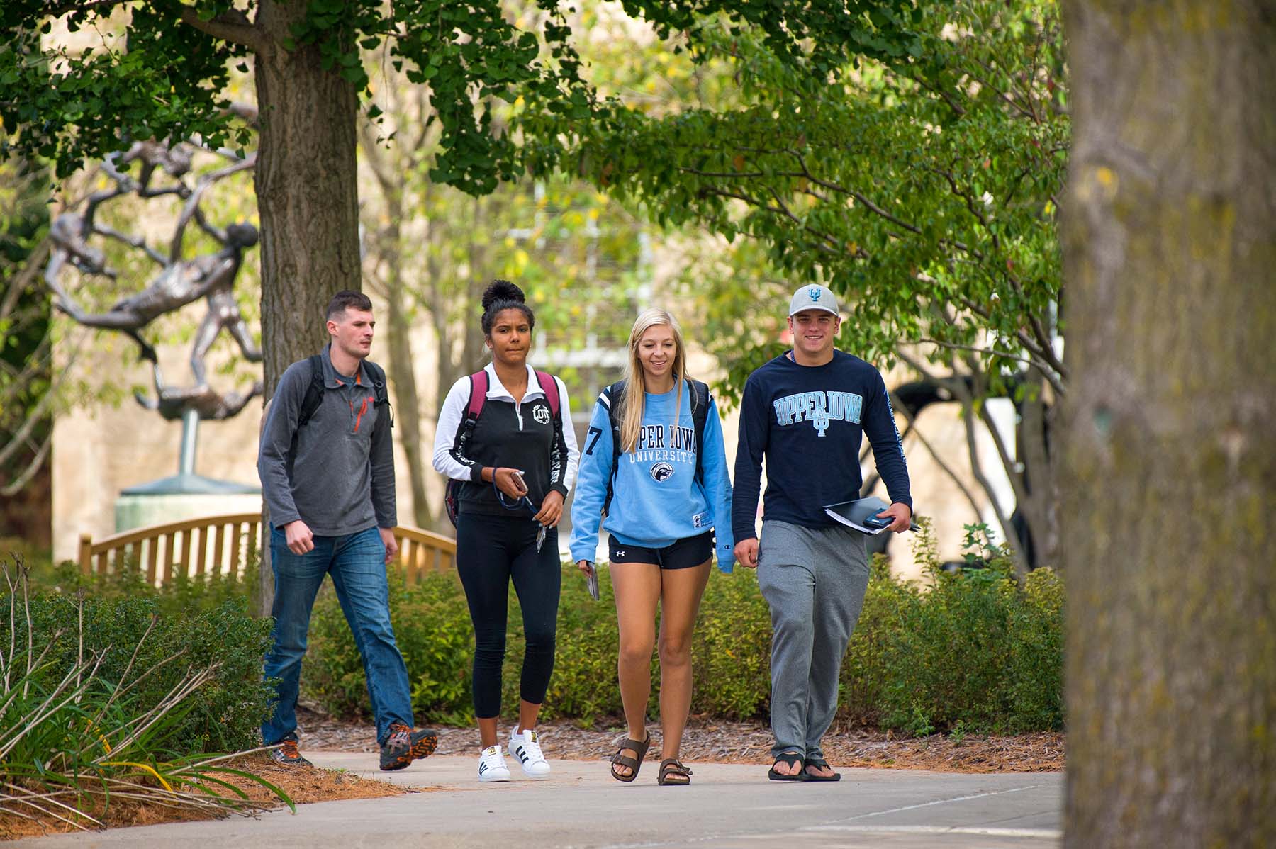 UIU Students walking down a path on a fall day