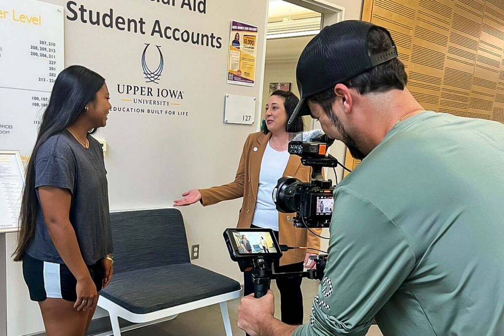 Two students converse with each other while getting filmed with a video rig