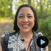 Headshot of Theresa Rademacker with video play preview button